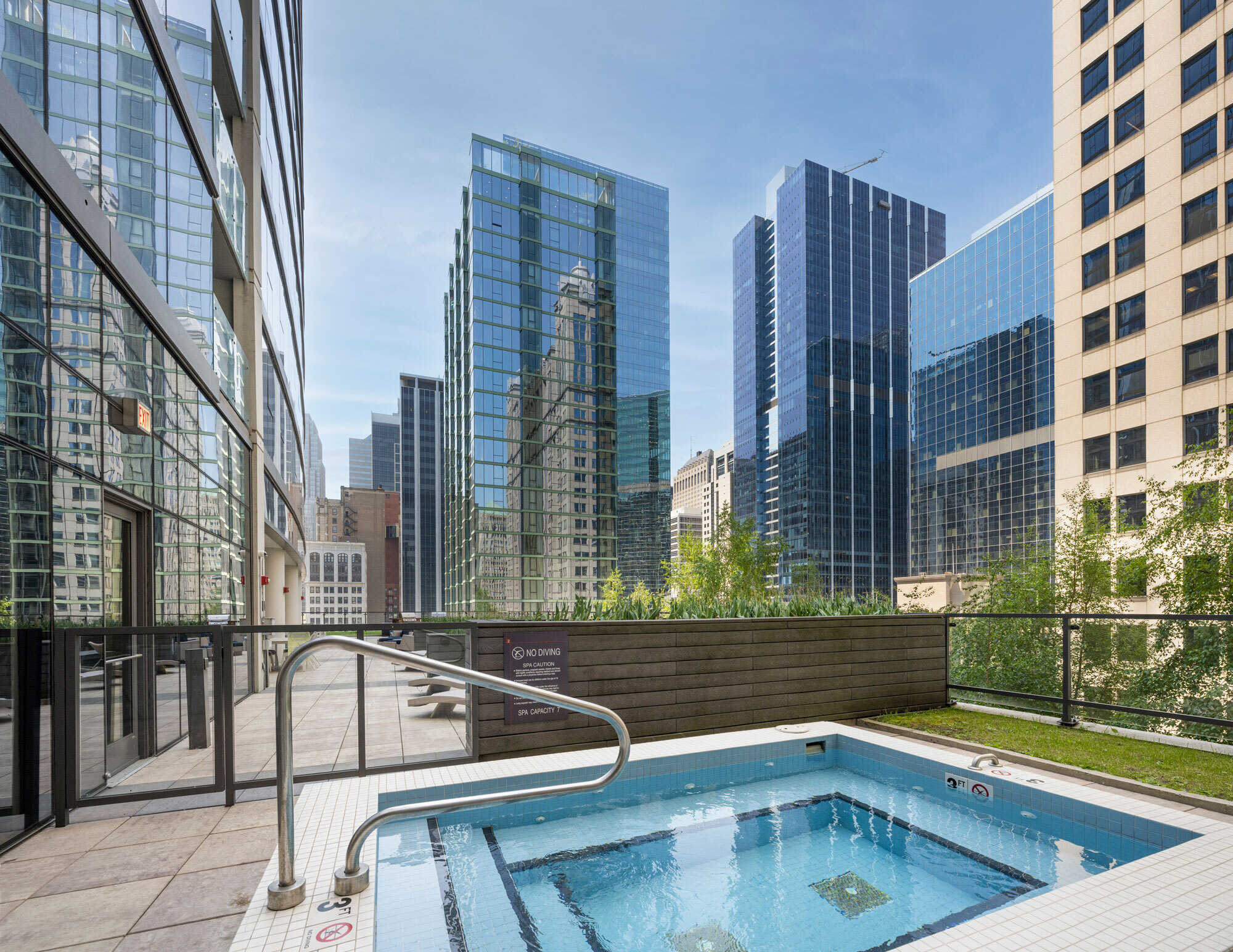 outdoor hot tub with view of buildings